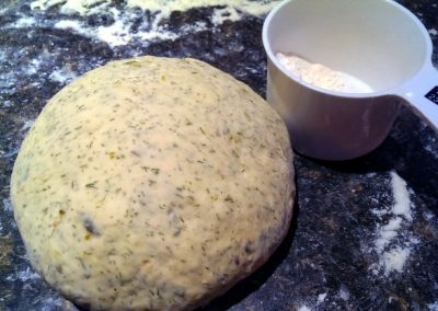 A ball of dough next to a measuring cup, ready for Cooking.