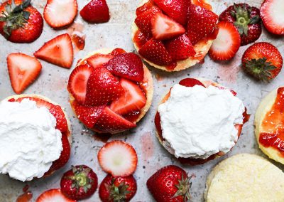 Strawberry shortcakes with whipped cream and strawberries cooked with basil.