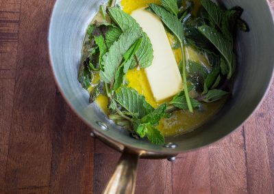 Cooking with mint: A pan sizzling with butter and fresh mint leaves.