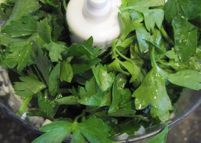 Fresh parsley and mint in a food processor.